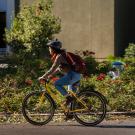 Student wearing helmet on bike.